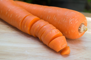 fresh carrots on wooden board