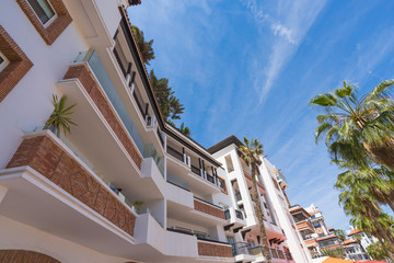 Living house with appartments and balconies in arabian style with sky background. Selective focus.