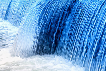 Blue-colored small waterfall in the wild