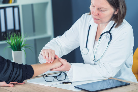 Female Patient At Orthopedic Doctor Medical Exam For Wrist Injur