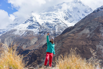 Hiker making selfie with beautiful mountains snowy peaks on background. Travel concept. Himalayas, Nepal