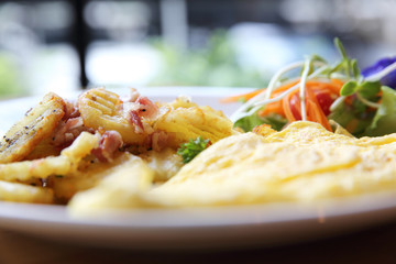 A delicious home style breakfast with crispy bacon, eggs omelett