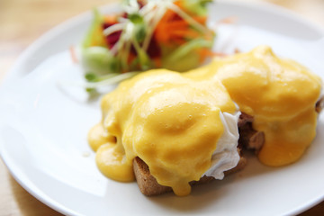 egg benedict on wood background