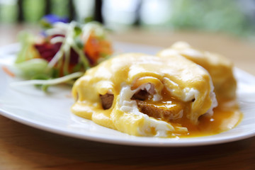 egg benedict on wood background