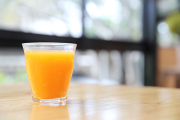 Orange juice on wood background