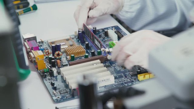 Some computer USB port components over motherboard background. Repair of laptops and computer motherboards. computer repair wizard examines laptop motherboard, using a screwdriver. Motherboard.