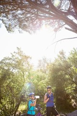 Senior couple standing with their bikes 