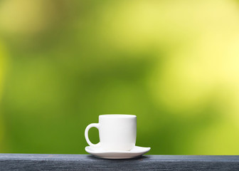 white coffee cup on  green bokeh background