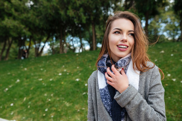 Incredible young caucasian lady touching her scarf in cage print