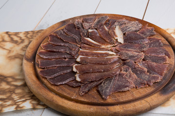 Jerky meat sliced on wooden board