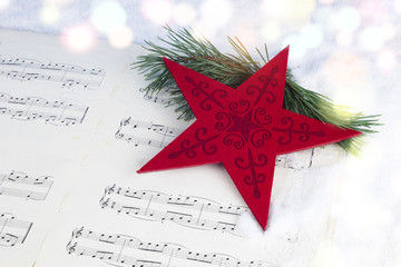 Fototapeta na wymiar Christmas decoration with pine tree, red star and musical score