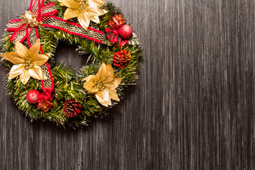 Christmas background with festive decoration and toys.On dark wood surface.