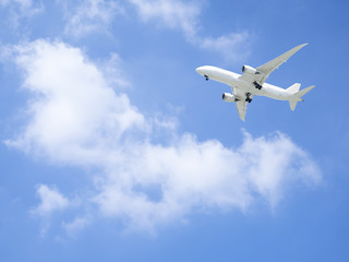Fototapeta na wymiar Airplane flying under blue sky 5