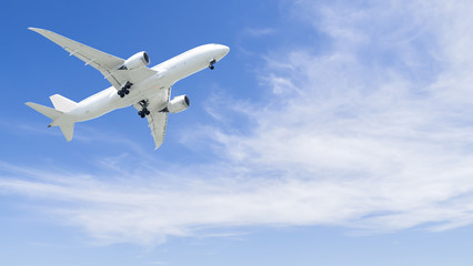 Fototapeta na wymiar Airplane flying under blue sky 4