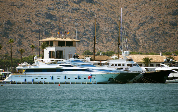 Many luxury yachts in the harbor.