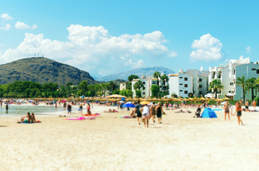 Lot of people resting on the summer beach. Blurred image.