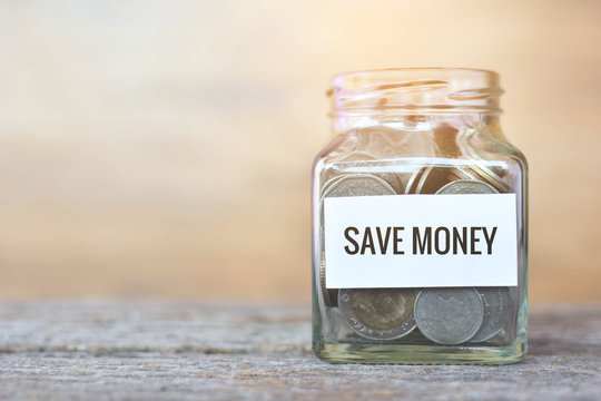 Money in a glass jar with "save money" word. concept siphons money