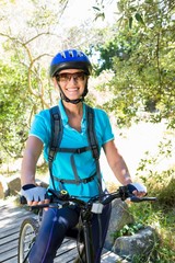 Senior woman is smiling with her bike