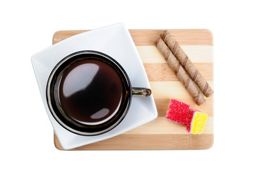 Time for a cup of coffee. Top view of a still-life with a cup of coffee,chocolate crispy rolls on the board with a pronounced texture