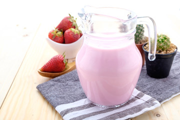 Fresh made Strawberry Milk on an old wooden table