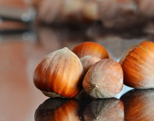 Hazelnuts on shiny tabletop