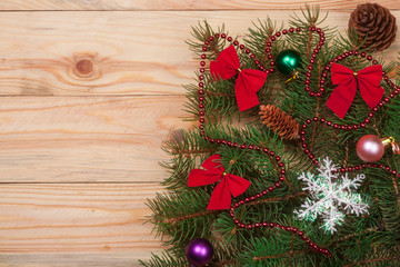 Fototapeta na wymiar decorated Christmas fir branch on a light wooden background