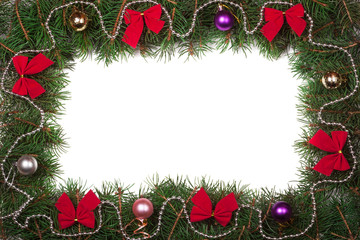 Christmas frame made of fir branches decorated with bows and balls isolated on white background