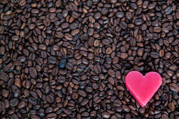 Red soap heart on coffee beans