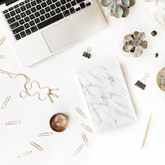 feminine workspace with laptop, marble diary, golden pen on white background. flat lay, top view