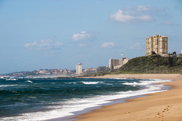  Empty Beach Against City Skyline and Blue Sky