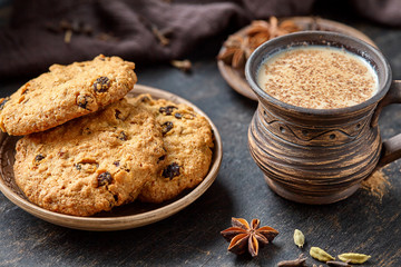Masala pulled tea chai latte traditional hot Indian sweet milk spiced drink, ginger, cinammon fresh spices blend, anise organic infusion healthy wellness beverage teatime ceremony in rustic clay cup