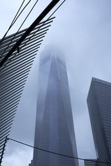 NEW YORK CITY - SEPTEMBER 30, 2016: One World Trade Center shrouded in fog next to the Transportation Hub by Calatravas