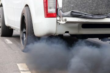Air pollution from vehicle exhaust pipe on road