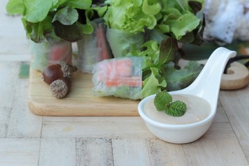 Fresh vegetable salad roll with salad dressing.