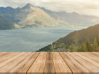 Wooden board empty table in front of blurred background. Perspective brown wood table over blur sea and mountain landscape background - can be used mock up for display or montage your products.