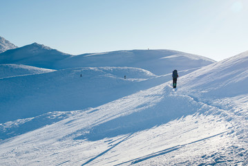 Fototapeta na wymiar Single tourist climb to the snow-capped mountain top in the Carp