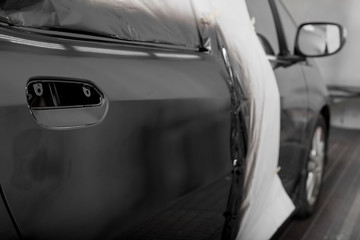 Fototapeta premium Auto body repair series : Black car after repaint in paint booth