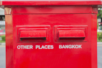 Posting airmail letters in a letterbox in Bangkok