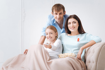 Fototapeta premium Cheerful tolerant family watching news