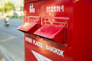 Posting airmail letters in a letterbox in Bangkok - obrazy, fototapety, plakaty