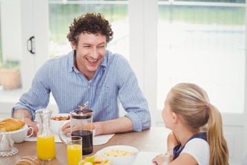 Fototapeta na wymiar Daughter and father having breakfast 