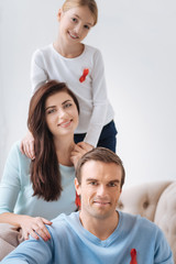 Fototapeta premium Happy pleasant family supporting AIDS prevention