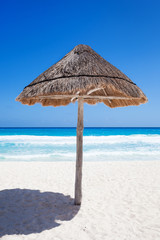 Straw grass shade umbrella on seaside