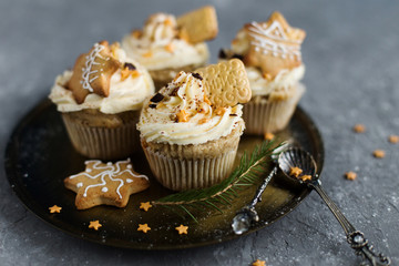 Cupcakes, adorned with Christmas decorations on a gray background