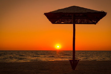 umbrella on the beach against sunset
