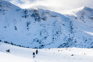 Fototapeta na wymiar A tourist with a backpack are trekking in beautiful winter Carp