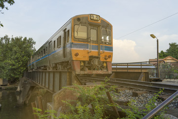 Fototapeta na wymiar old train on railway bridge arrived train station in Thailand sun light evening