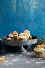 Christmas cupcakes with cookies on the grey stand