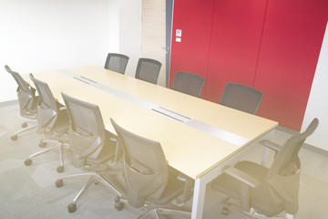 wooden table in meeting room white board sunlight from window