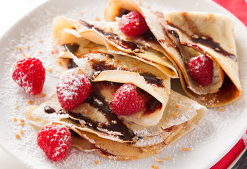 Pancakes with berries and maple syrup